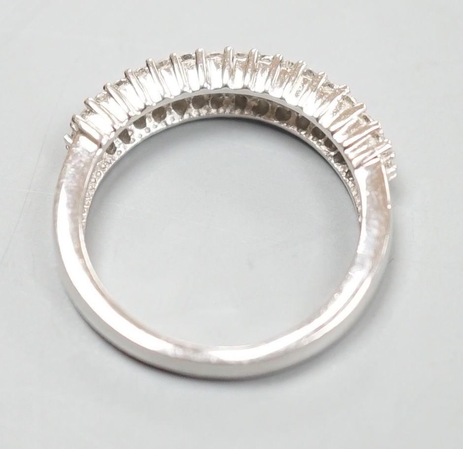 A modern 18ct white gold and three row diamond chip set half hoop ring, size K/L, gross weight 4.2 grams